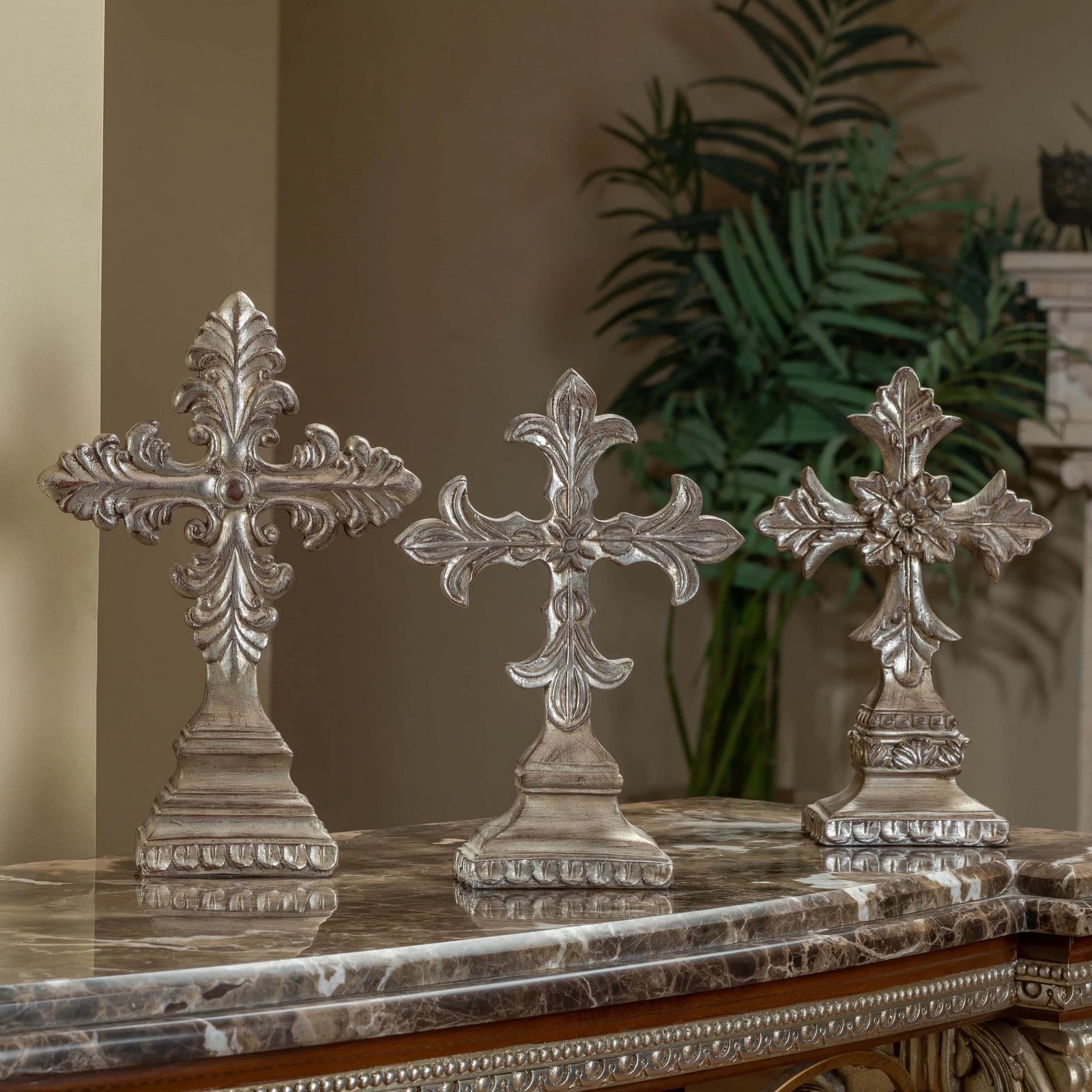 Classic decorative crosses used as table accessories, featuring intricate design and a timeless aesthetic, styled on a tabletop display.


