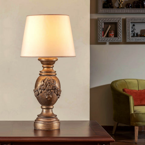 Classic Fiyounka Table Lamp with elegant bow design on wooden side table – warm ambient lighting for modern and classic interiors.
