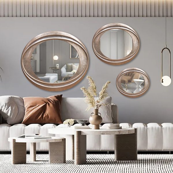 Set of 3 Modern I TWIST wall mirrors featuring abstract, curved designs with sleek frames arranged in a decorative pattern.


