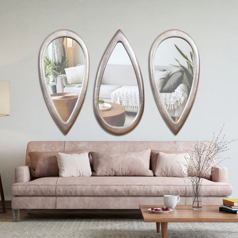 "Modern Tear Drop Mirror from Daleenz Store with a smooth teardrop shape, mounted on a neutral-toned wall in a contemporary interior setting."

